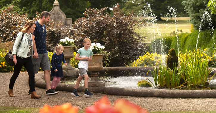 family walking through medieval walled garden at Raby Castle